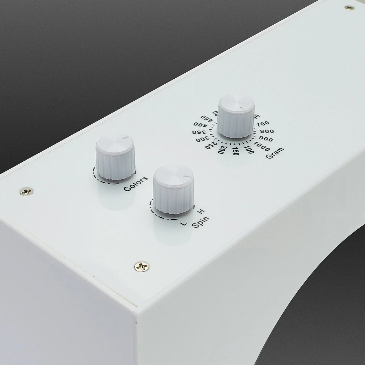 Close-up of the adjustment controls on top of the white levitating saber stand
